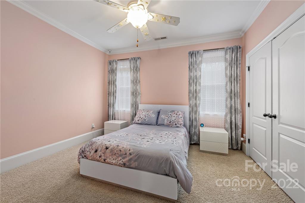 15501 Eagleview Drive Charlotte, NC 28278 - Photo 27 of 40 a bedroom with a large bed and a chandelier