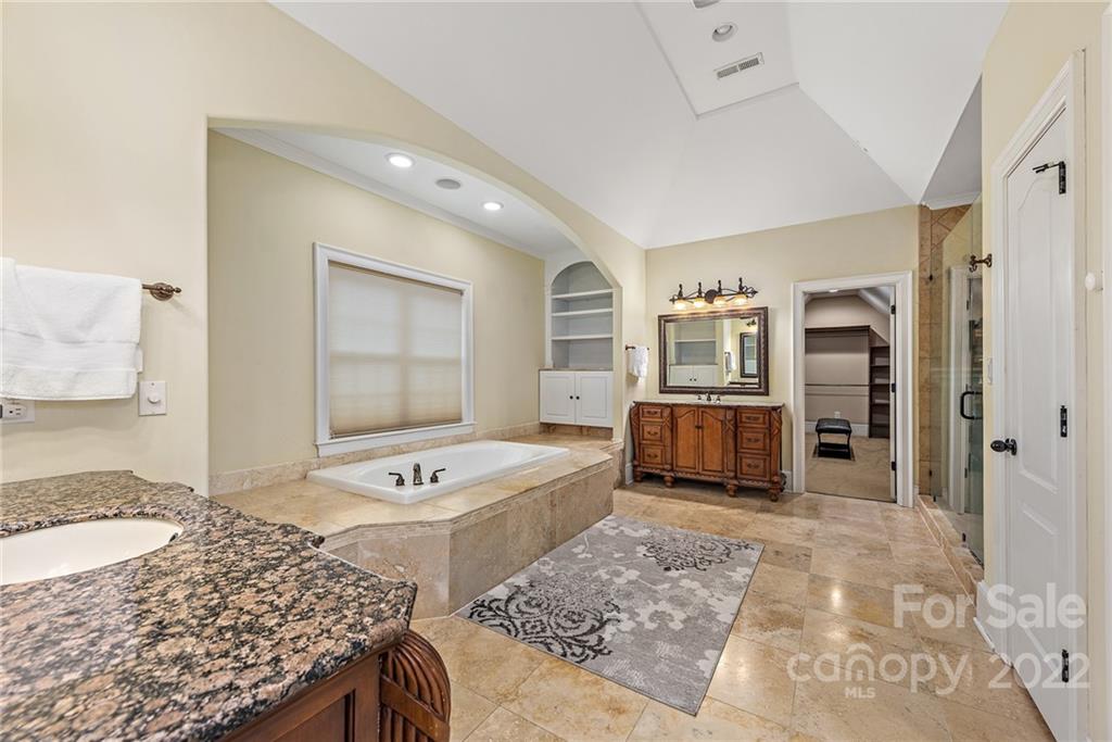 15501 Eagleview Drive Charlotte, NC 28278 - Photo 31 of 40 a spacious bathroom with a granite countertop sink and a mirror
