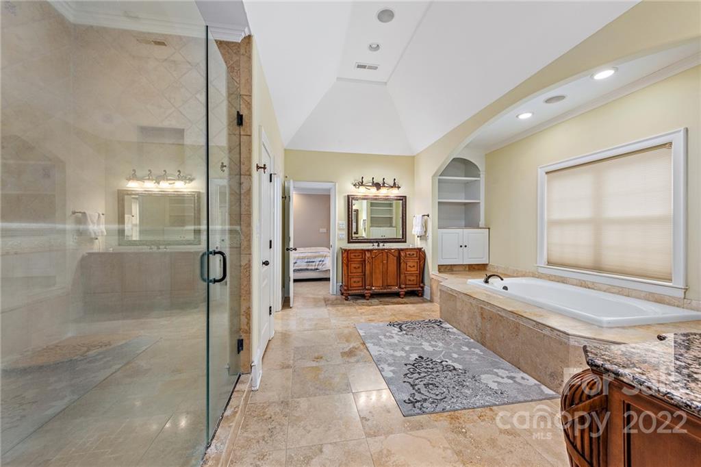 15501 Eagleview Drive Charlotte, NC 28278 - Photo 32 of 40 a spacious bathroom with a tub shower and mirror