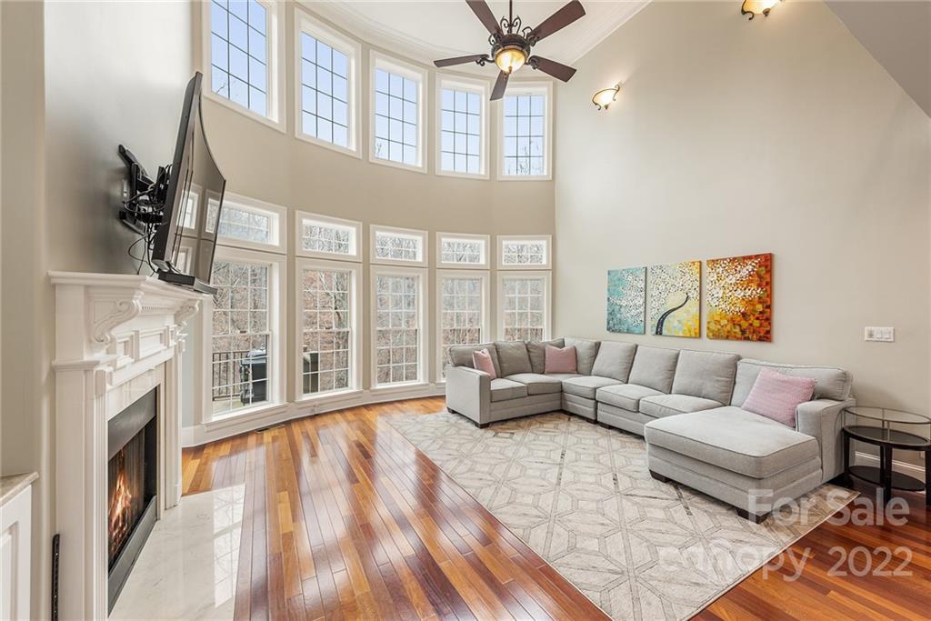 15501 Eagleview Drive Charlotte, NC 28278 - Photo 5 of 40 a living room with furniture large window and a fireplace