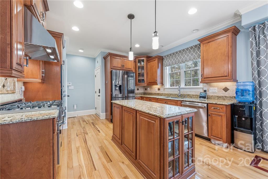 15501 Eagleview Drive Charlotte, NC 28278 - Photo 9 of 40 a kitchen with stainless steel appliances granite countertop a stove a sink dishwasher and a refrigerator with wooden floor