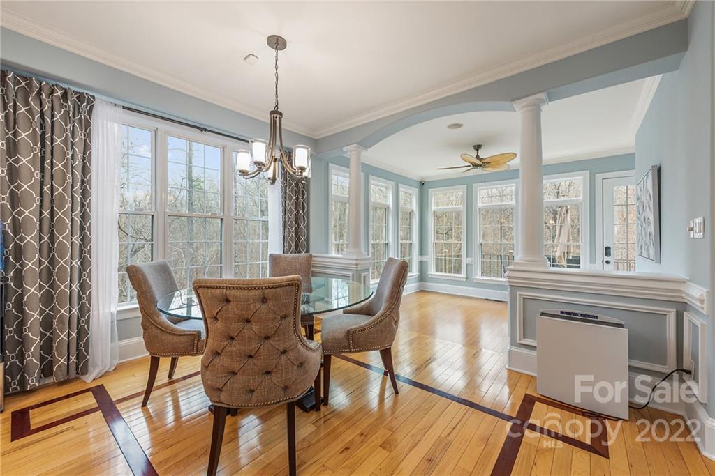 15501 Eagleview Drive Charlotte, NC 28278 - Photo 10 of 40 a view of a dining room with furniture large windows and wooden floor