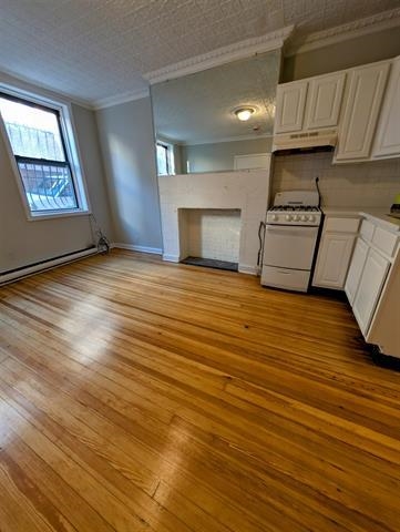 504 Court Street, Unit 1 Hoboken, NJ 07030 - Photo 4 of 12 a view of a kitchen with furniture and a fireplace