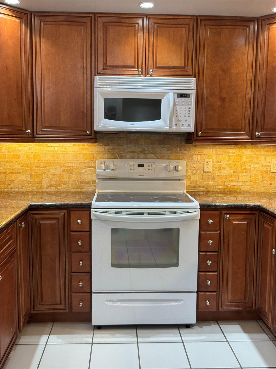 9245 Flynn Circle, Unit 8 Boca Raton, FL 33496 - Photo 14 of 36 a kitchen with granite countertop cabinets stainless steel appliances and stove