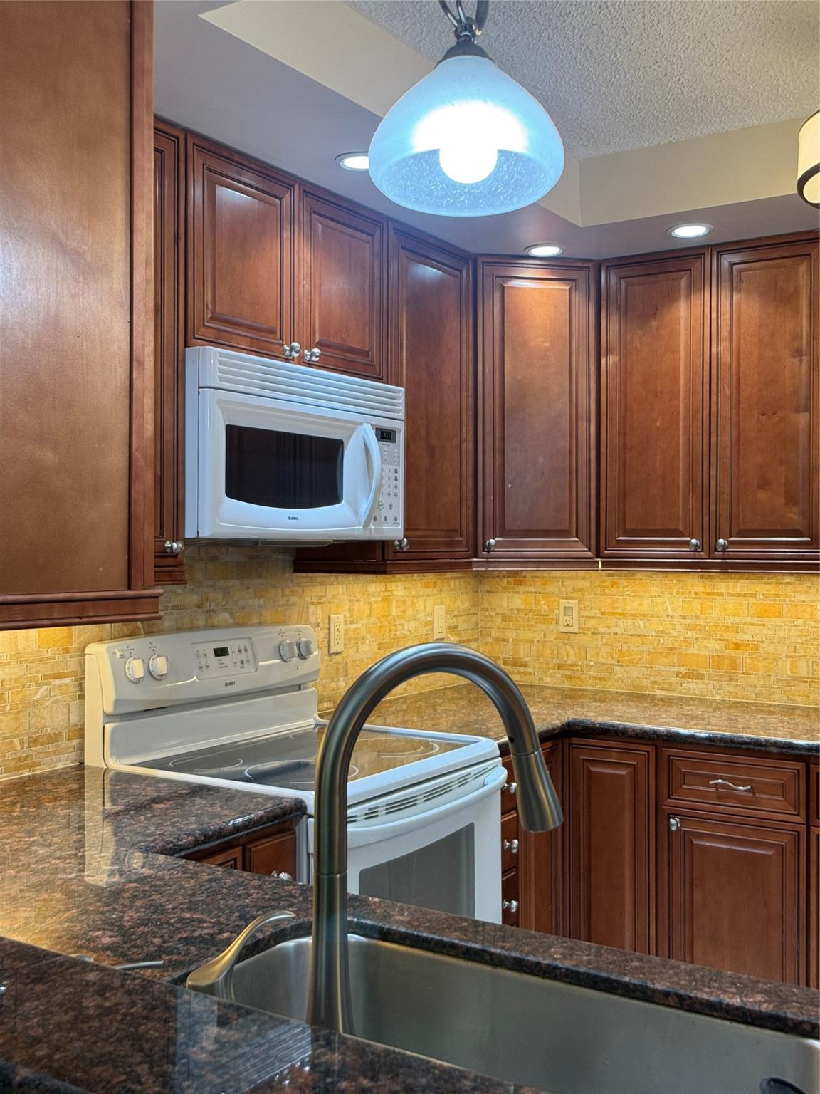 9245 Flynn Circle, Unit 8 Boca Raton, FL 33496 - Photo 18 of 36 a kitchen with a sink and cabinets