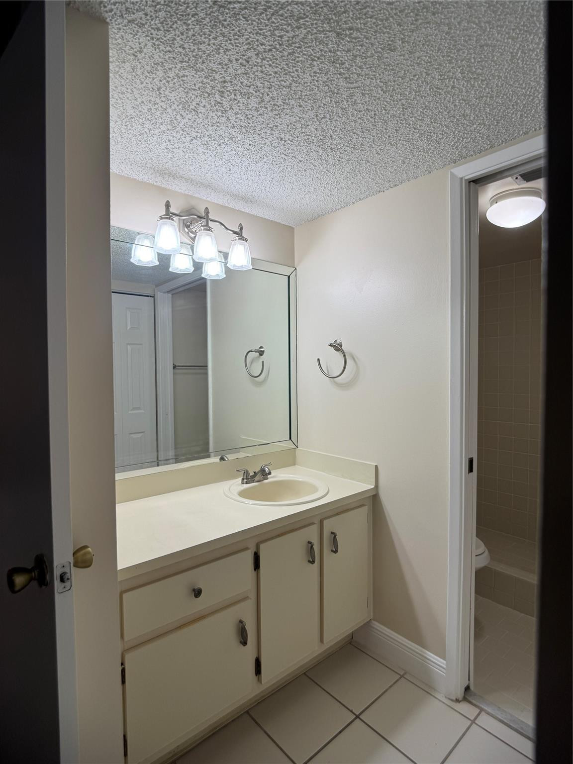 9245 Flynn Circle, Unit 8 Boca Raton, FL 33496 - Photo 22 of 36 a spacious bathroom with a granite countertop sink a mirror and a shower