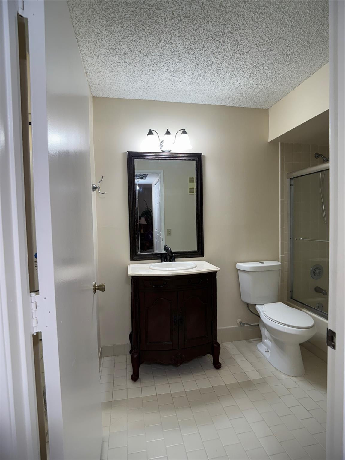 9245 Flynn Circle, Unit 8 Boca Raton, FL 33496 - Photo 25 of 36 a bathroom with a sink a toilet and shower