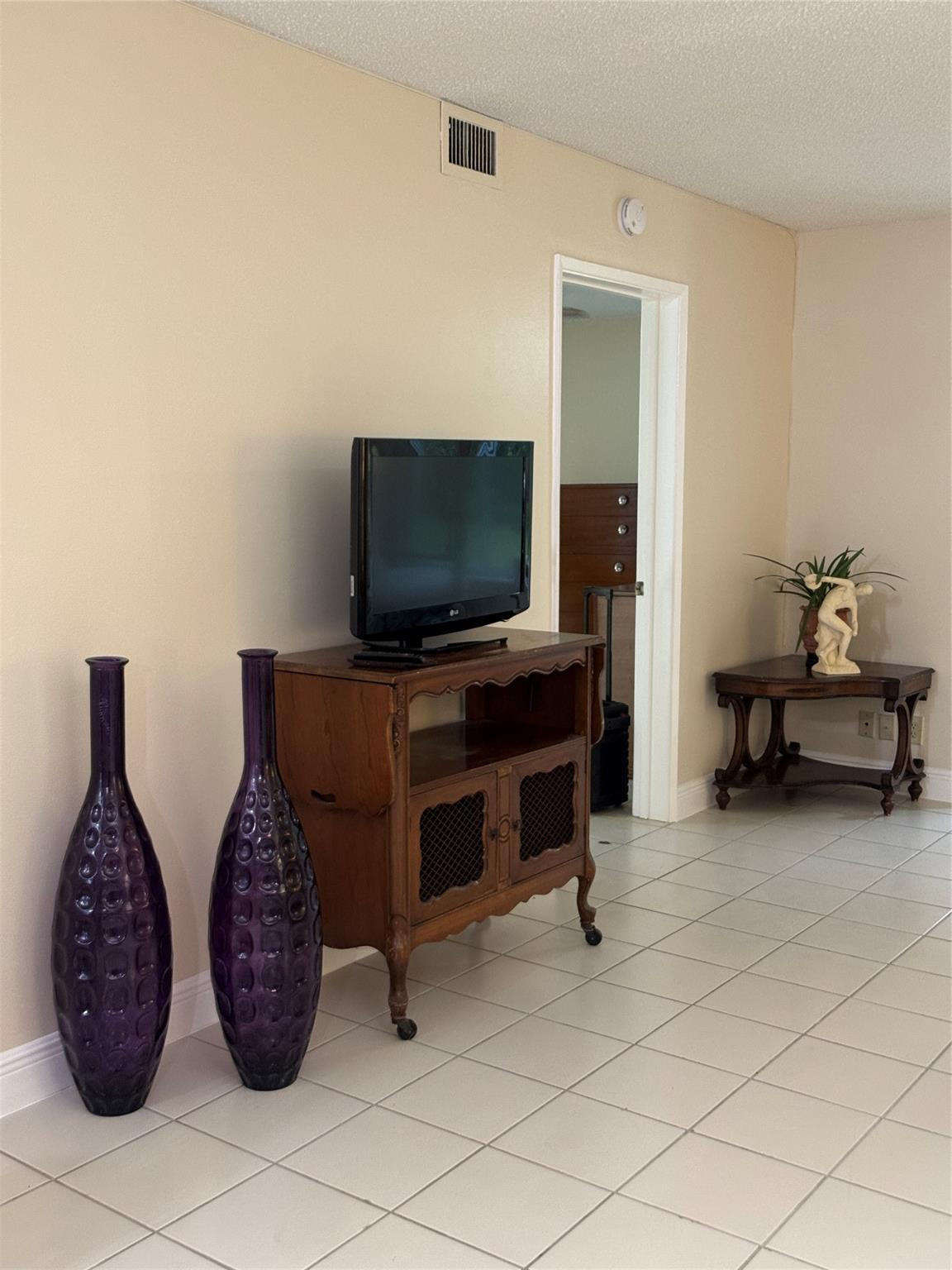 9245 Flynn Circle, Unit 8 Boca Raton, FL 33496 - Photo 10 of 36 a living room with furniture and a flat screen tv