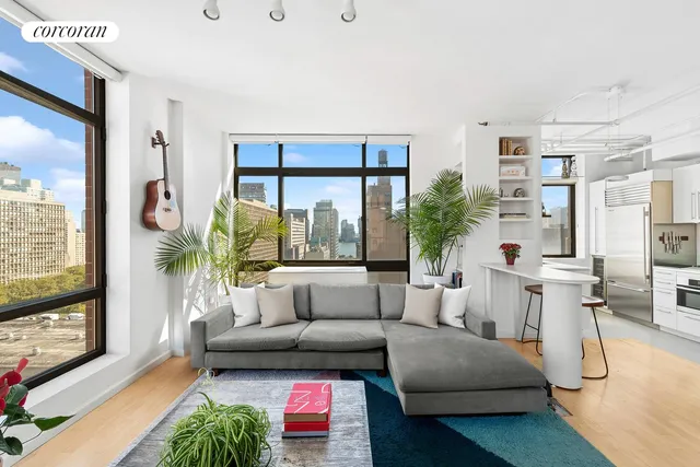 a living room with furniture large window and a flat screen tv