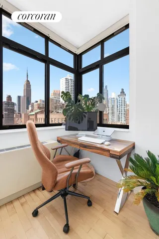 a bedroom with a large bed and a potted plant