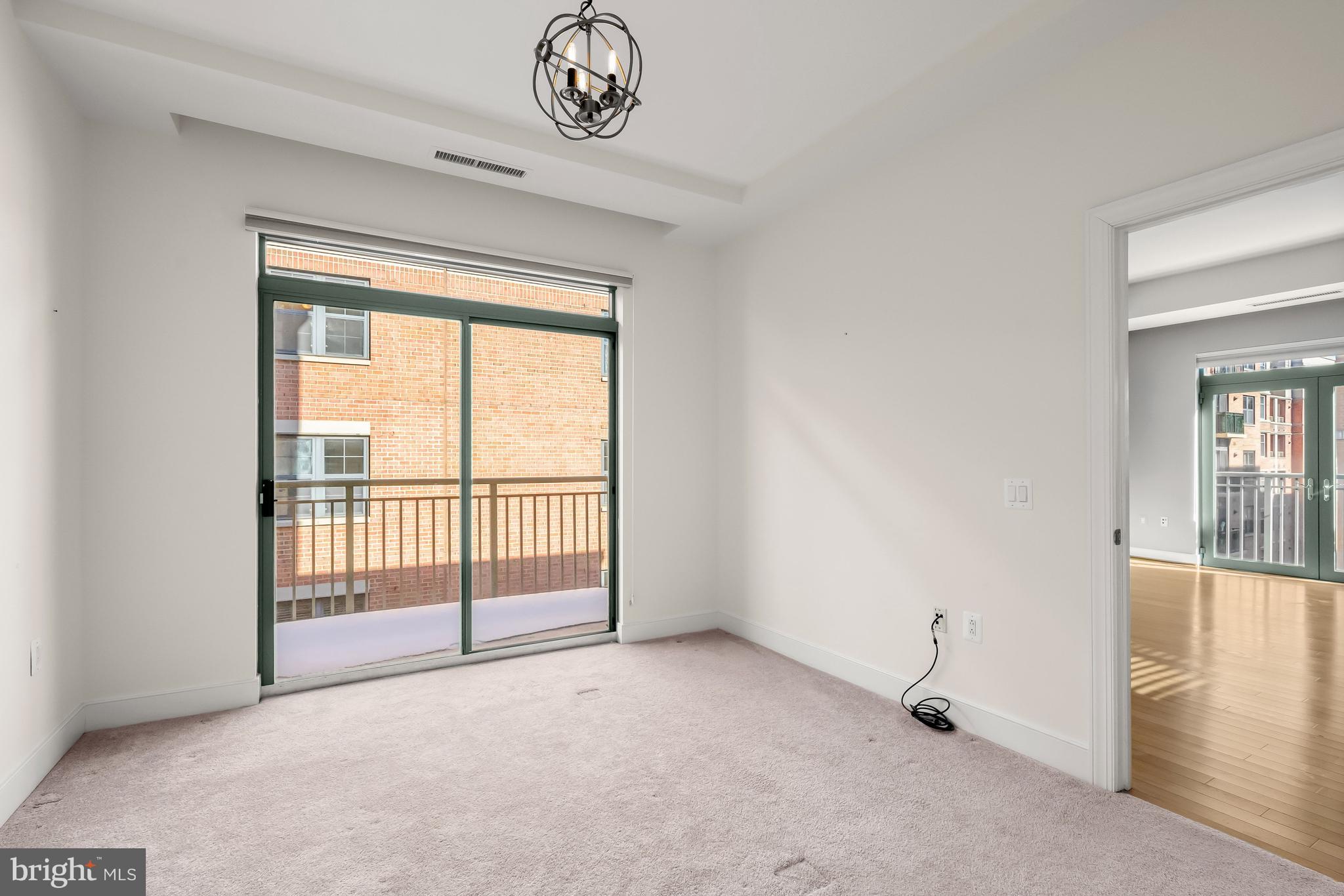 2425 L Street Northwest, Unit 709 Washington, DC 20037 - Photo 11 of 24 a view of a livingroom with an empty space and a balcony
