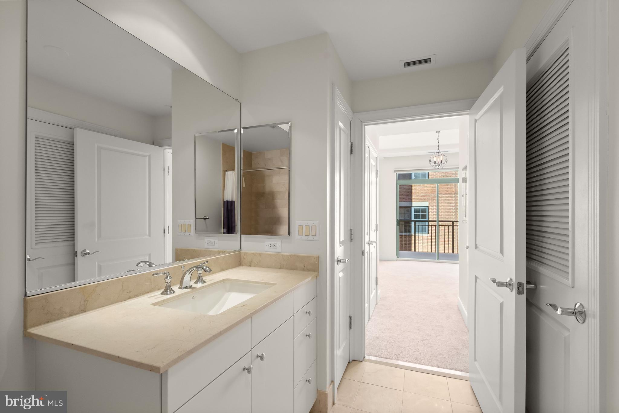 2425 L Street Northwest, Unit 709 Washington, DC 20037 - Photo 13 of 24 a bathroom with a sink double vanity and a mirror