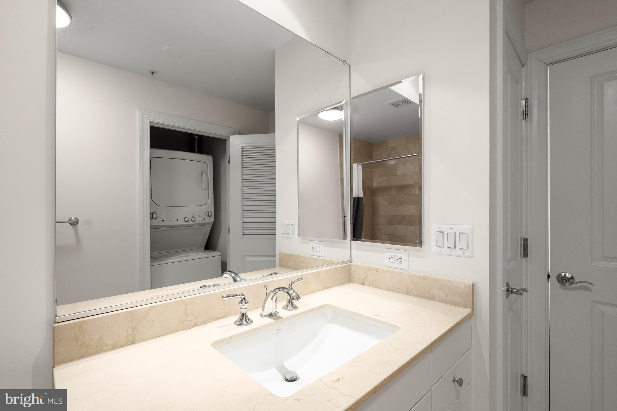 2425 L Street Northwest, Unit 709 Washington, DC 20037 - Photo 14 of 24 a bathroom with a sink and a mirror