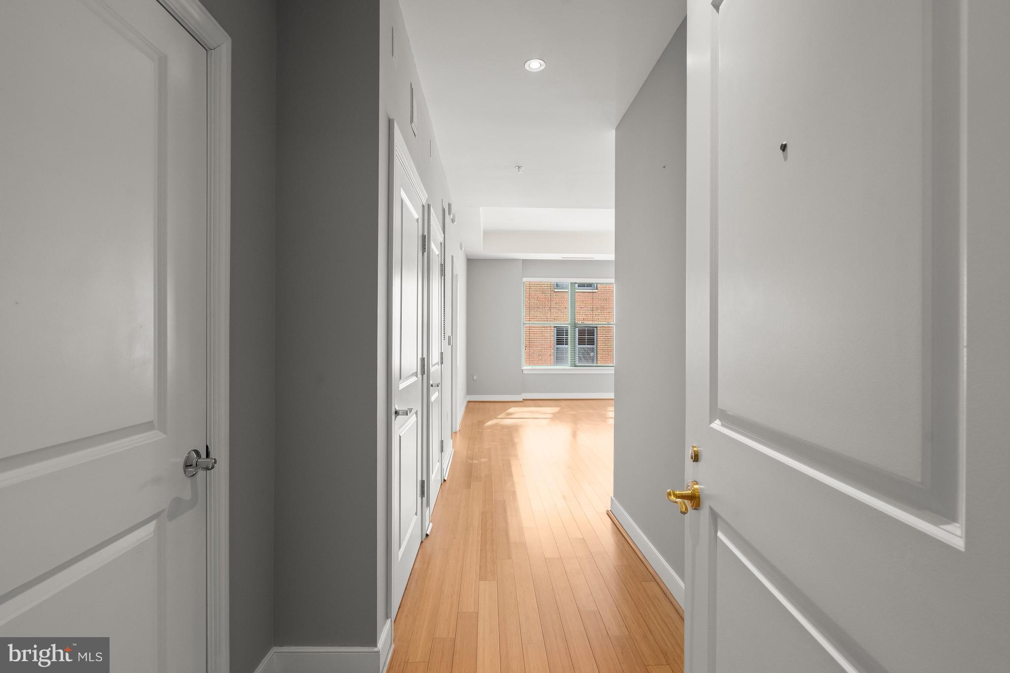 2425 L Street Northwest, Unit 709 Washington, DC 20037 - Photo 3 of 24 a view of a hallway with wooden floor and a bathroom