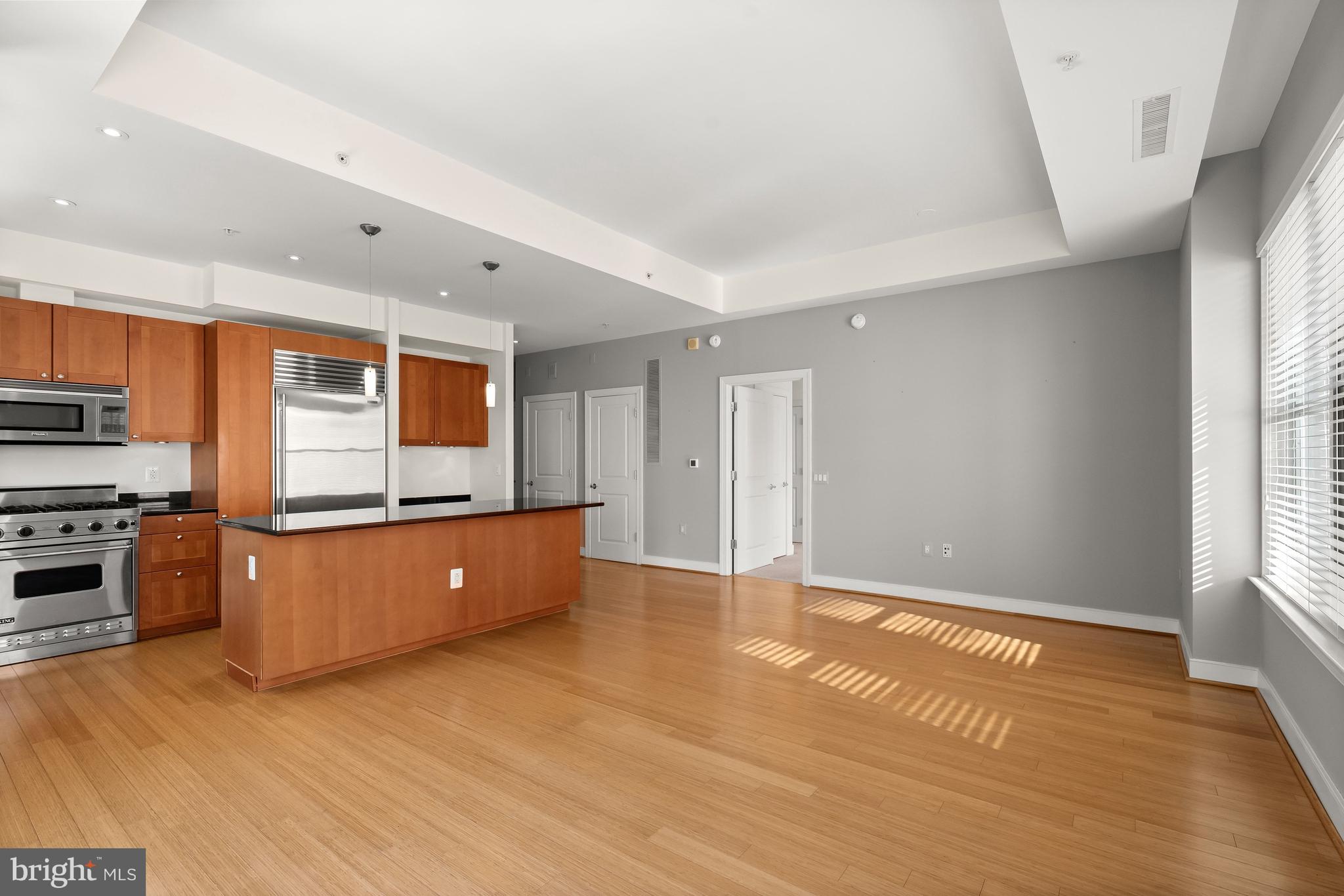 2425 L Street Northwest, Unit 709 Washington, DC 20037 - Photo 8 of 24 a kitchen with stainless steel appliances granite countertop a stove a sink and a refrigerator
