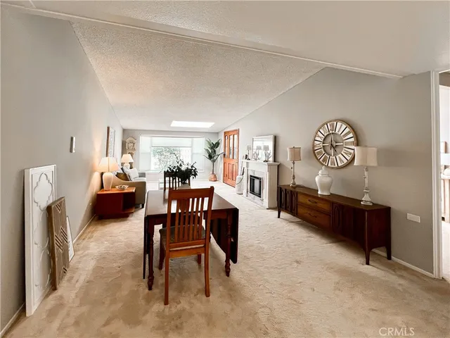 a living room with furniture a rug a fireplace and a table
