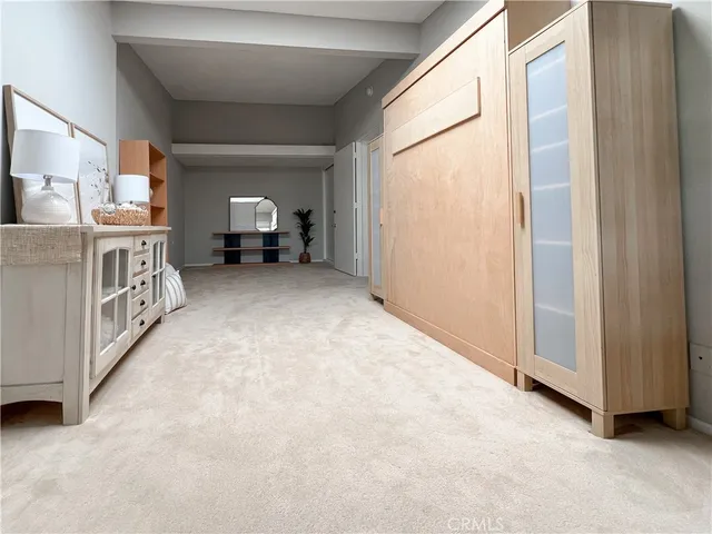 a view of a room with furniture and a window