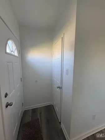 a view of a big room with wooden floor and a bathroom