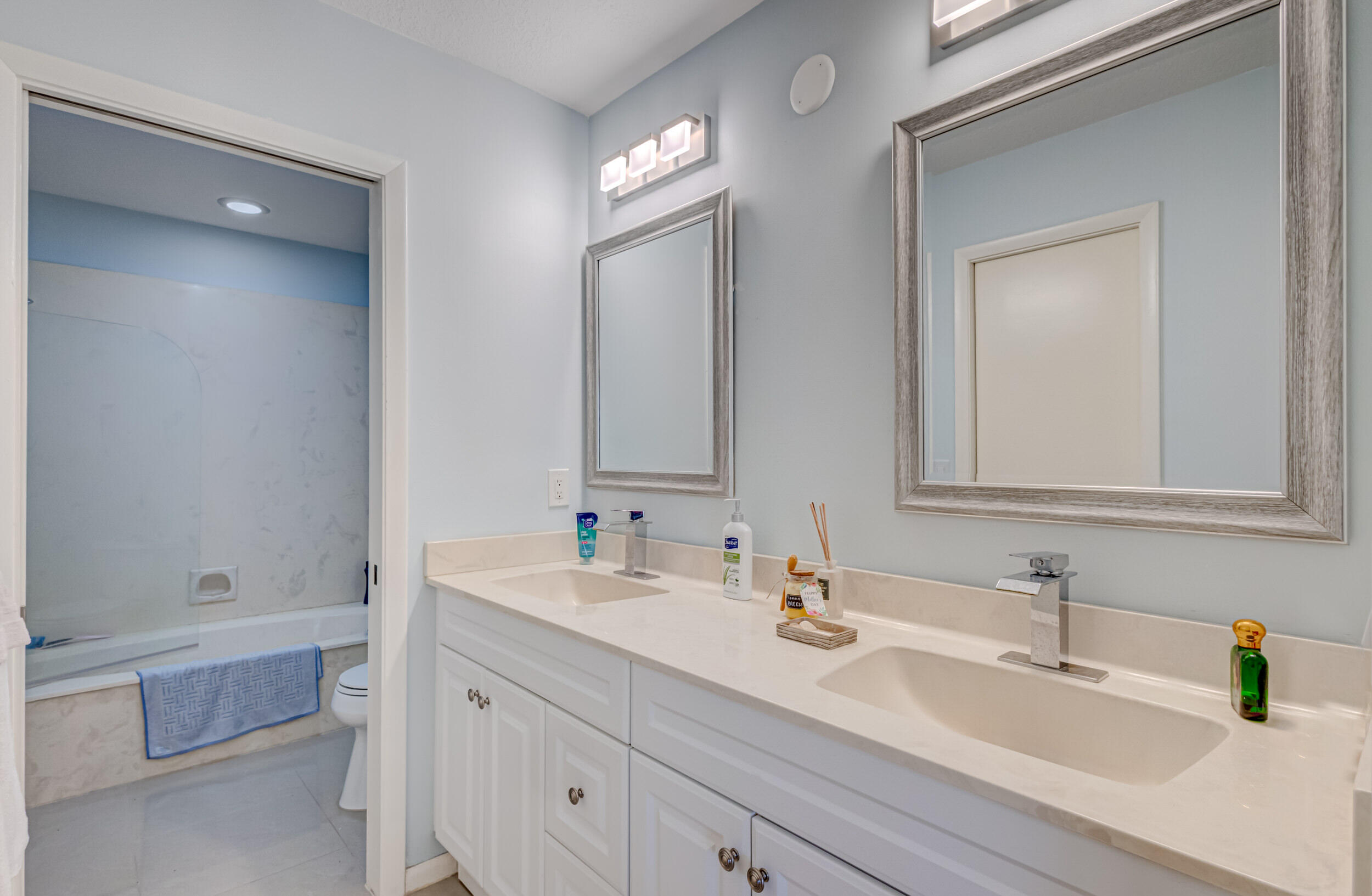 3793 Cape Pointe Circle Jupiter, FL 33477 - Photo 12 of 20 a bathroom with double vanity sink a mirror and a bathtub