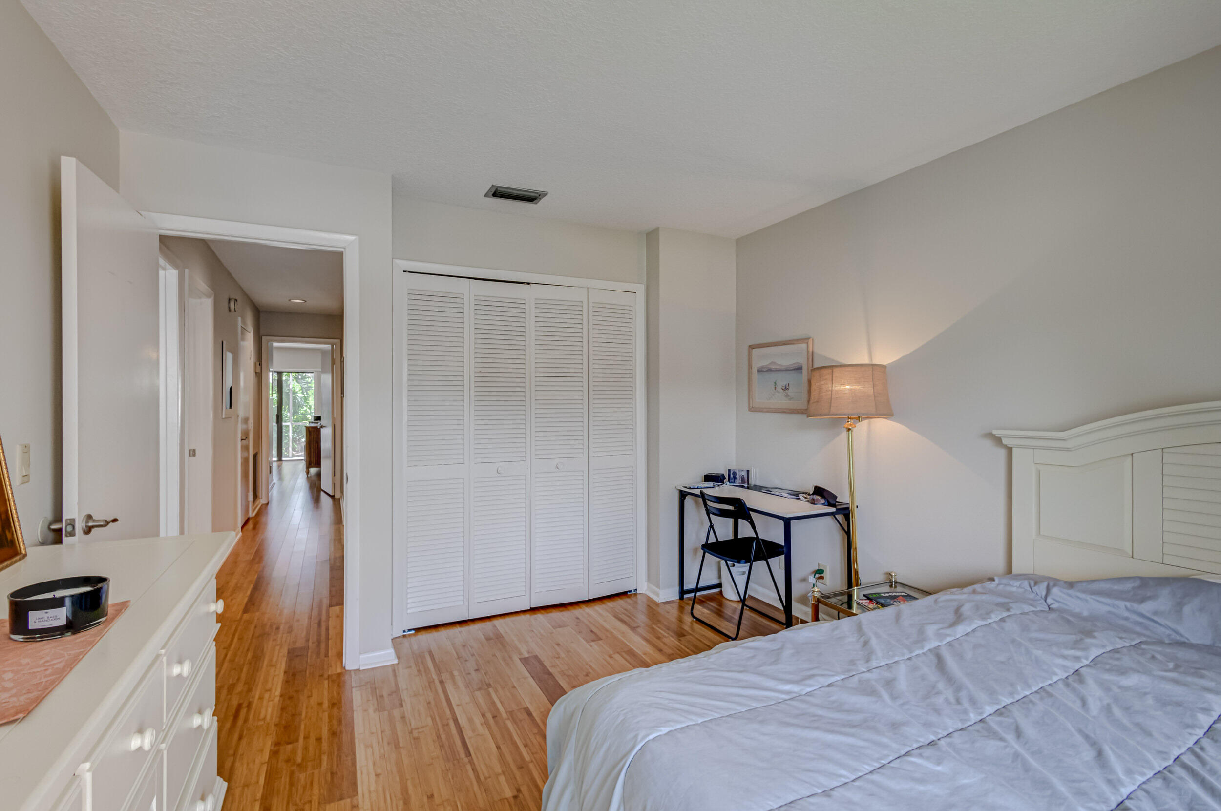 3793 Cape Pointe Circle Jupiter, FL 33477 - Photo 14 of 20 a bedroom with a bed and wooden floor