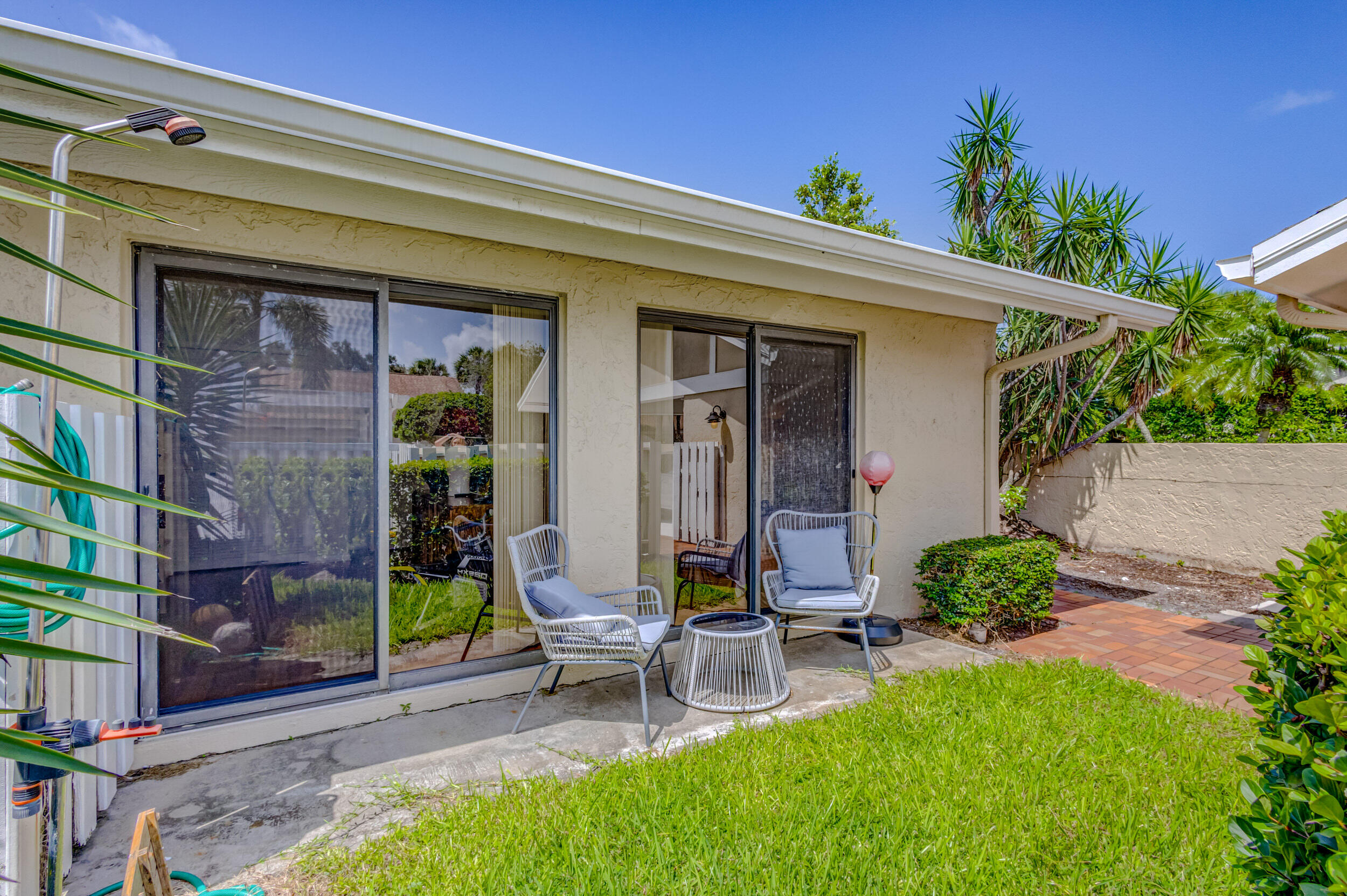 3793 Cape Pointe Circle Jupiter, FL 33477 - Photo 2 of 20 a view of a chair and table in backyard of the house