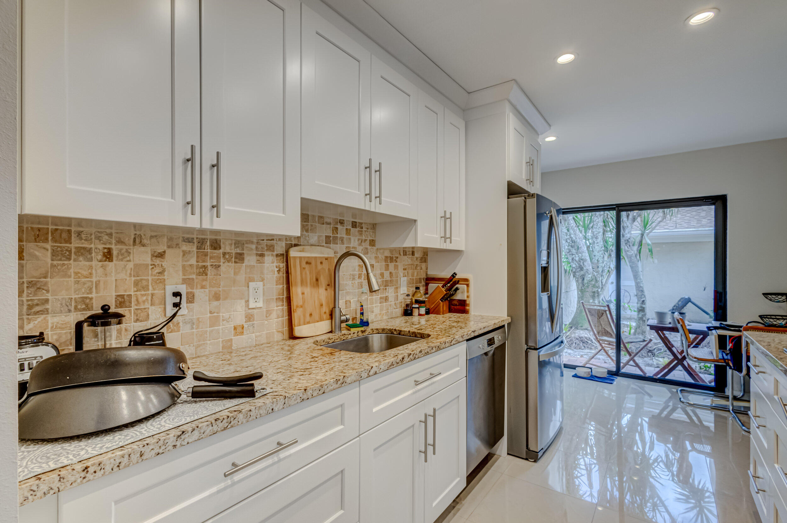 3793 Cape Pointe Circle Jupiter, FL 33477 - Photo 6 of 20 a kitchen with sink cabinets and outdoor view