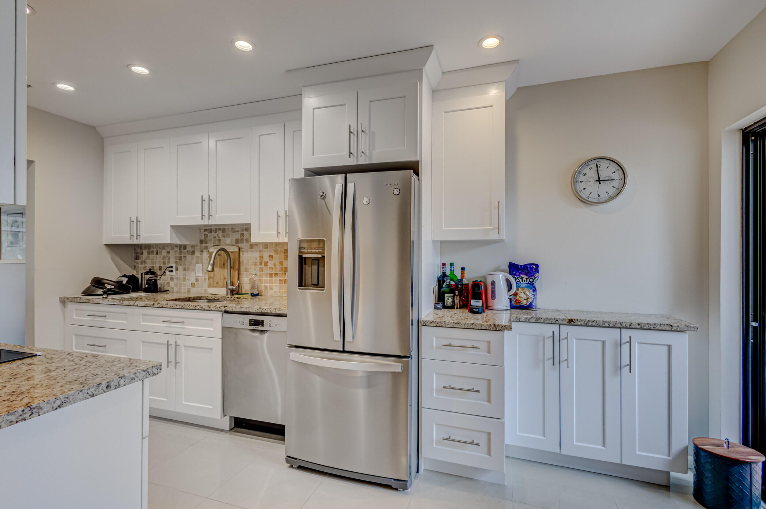 3793 Cape Pointe Circle Jupiter, FL 33477 - Photo 8 of 20 a kitchen with white cabinets and refrigerator