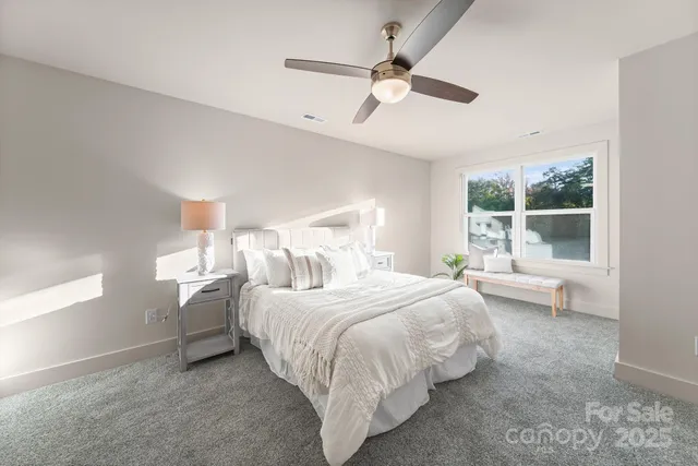 a bedroom with a bed and a large window