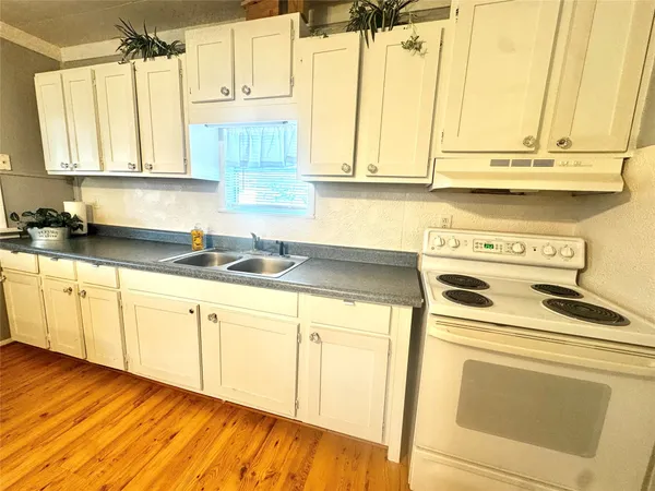 a kitchen with stainless steel appliances white cabinets and a sink