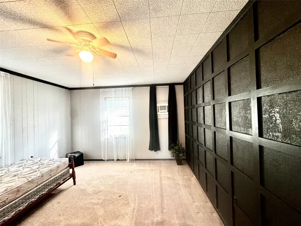 a bedroom with furniture and window