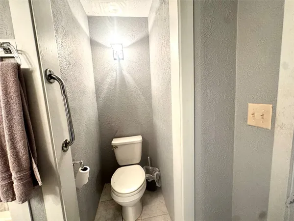 a bathroom with a toilet and a mirror