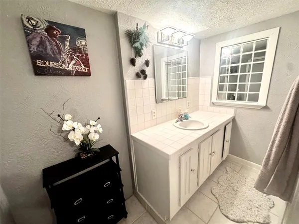 a bathroom with a sink a vanity and a mirror