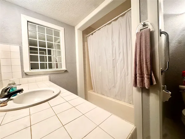 a bathroom with a tub and a window