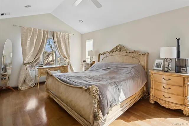 a spacious bedroom with a bed and a window