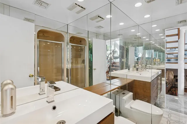 a bathroom with a sink a large mirror and a shower