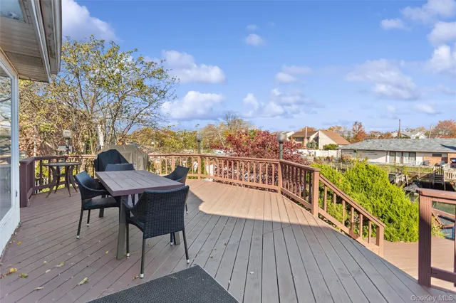 a view of a balcony with wooden floor and outdoor seating