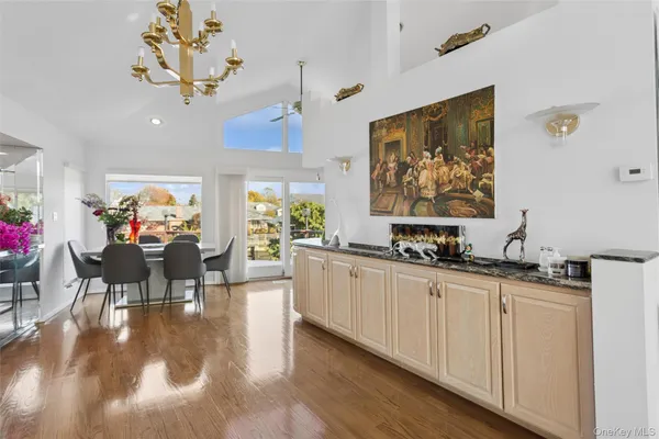 a very nice looking dining room with kitchen island furniture and a chandelier