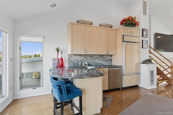 a kitchen with refrigerator and cabinets