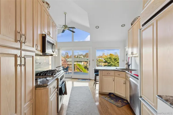 a kitchen with stainless steel appliances a stove a sink and a refrigerator