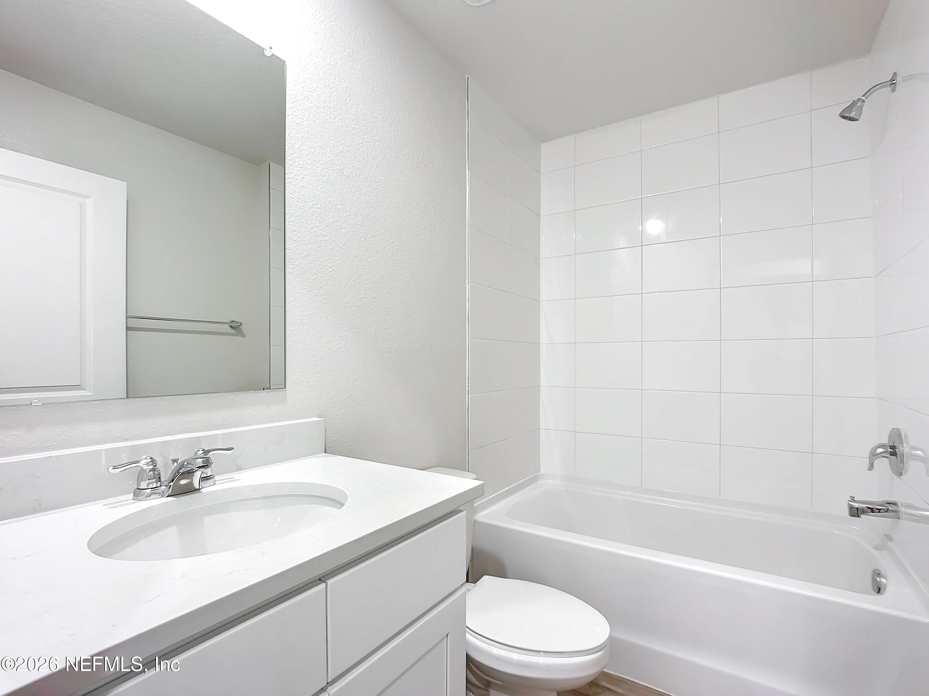 66 Rickenbacker Drive Palm Coast, FL 32164 - Photo 4 of 8 a bathroom with a granite countertop sink toilet and bathtub