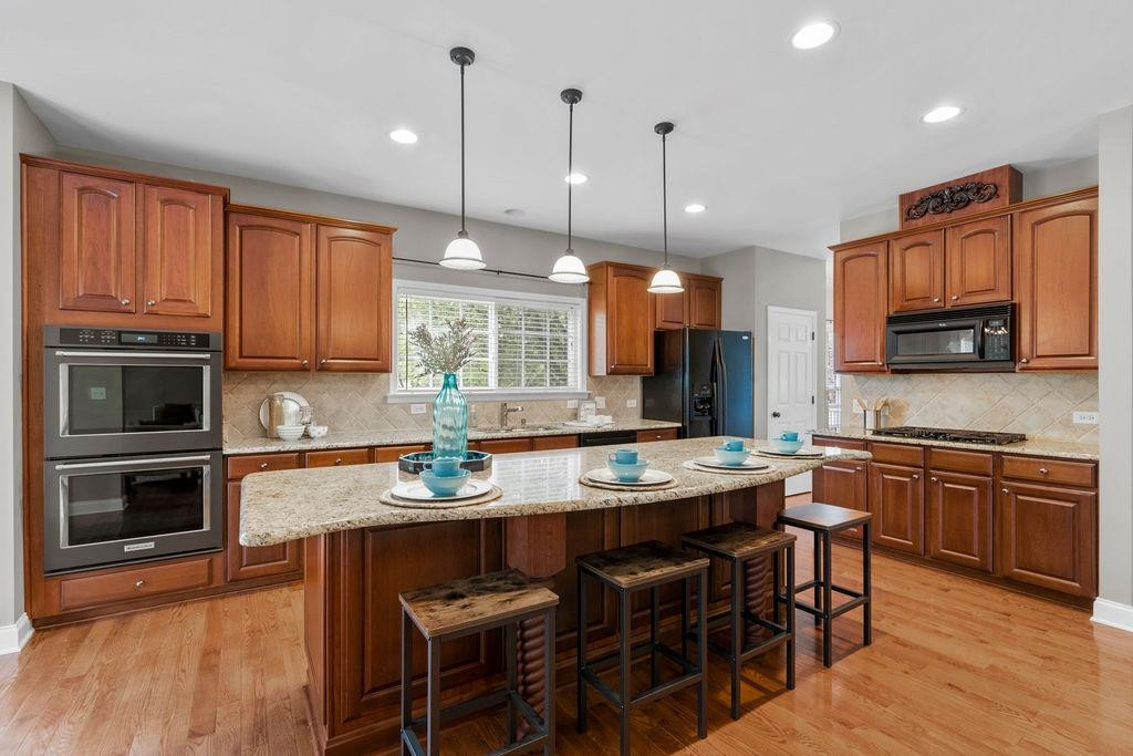 10702 Longholme Way Raleigh, NC 27614 - Photo 13 of 57 Chef's Kitchen with Double Ovens and Gas Stove
