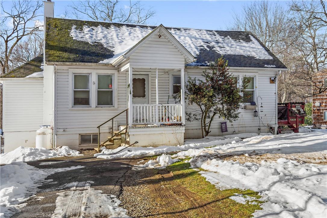 a front view of a house with a tree