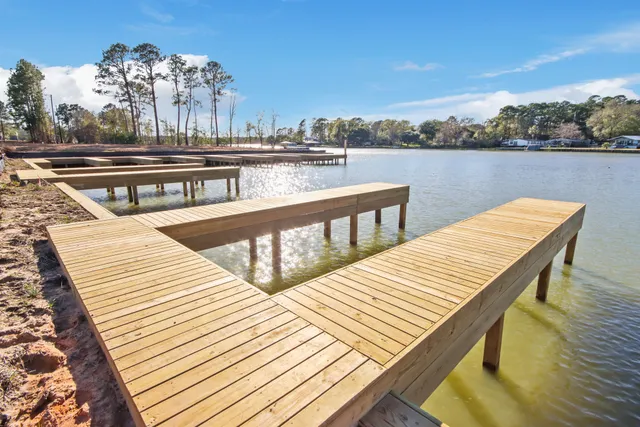 a view of a balcony with wooden chairs and floor to ceiling window