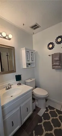 a bathroom with a sink toilet and mirror