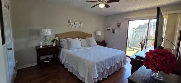 a bedroom with bed and wooden floor