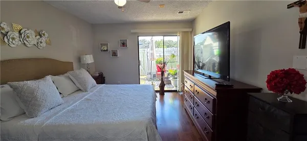 a living room with furniture a flat screen tv and a large window