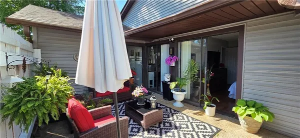 a front view of a house with outdoor seating