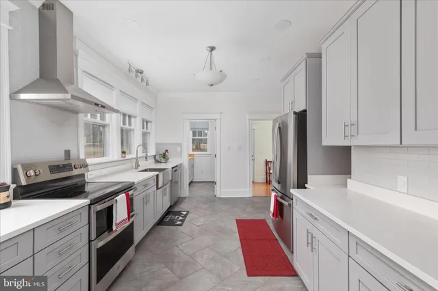 a view of a hallway with wooden floor and stairs