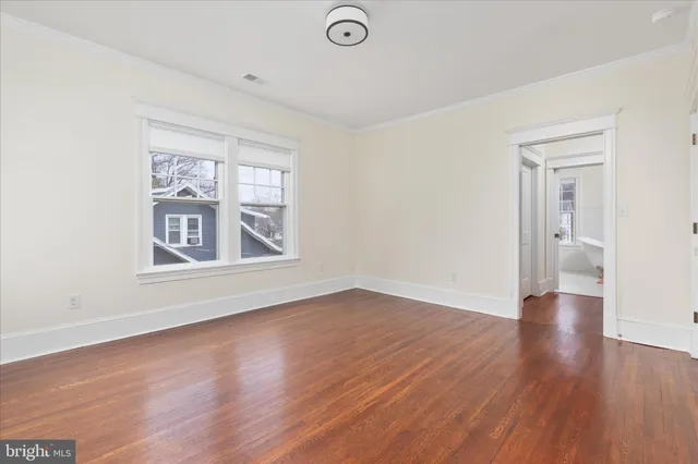 a view of a bedroom with furniture and a large window