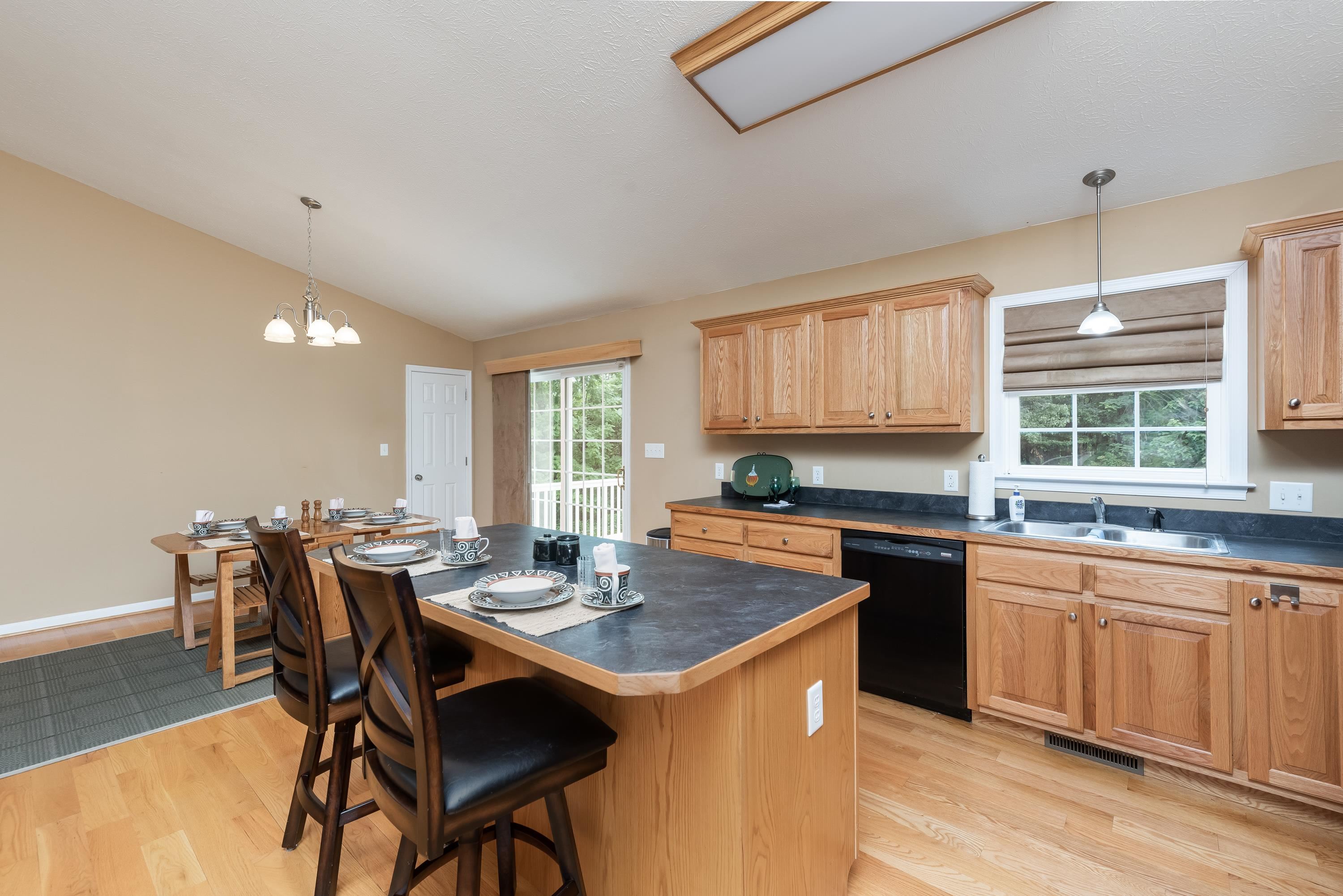 3934 Shutterlee Mill Road Staunton, VA 24401 - Photo 11 of 49 a kitchen with a stove a sink a dining table and chairs